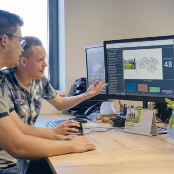 Twee GIS-specialisten van het bedrijfsbureau bezig met de dashboards.