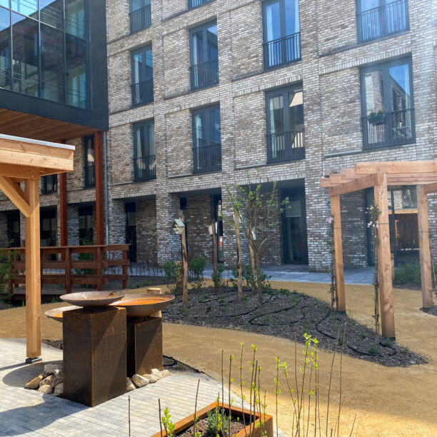 Waterschalen, pergola en overkapping kleuren het centrum van de tuin.